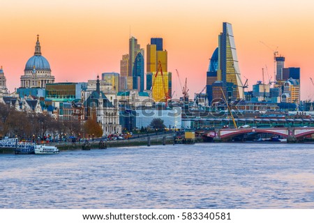 Sunset over the London cityscape against a cloudless sky
