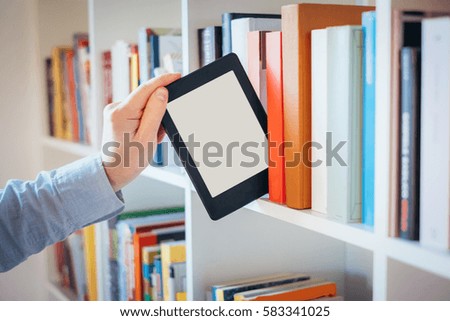 E-book reader and colorful bookshelf