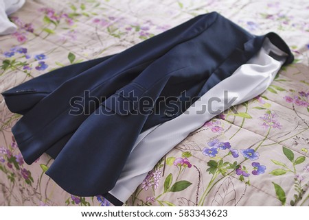 An image of a groom's jacket over the bed