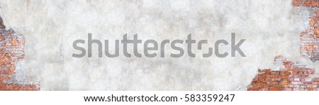 Old brick wall with peeling plaster, grunge background Royalty-Free Stock Photo #583359247