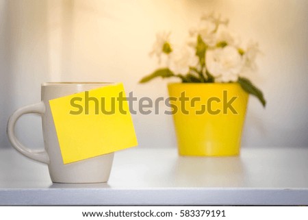 concept of coffee cup and note background window and flowers