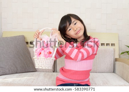 Joyful girl holding gift in her hands