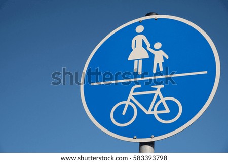 A road sign bike path pedestrian walkway