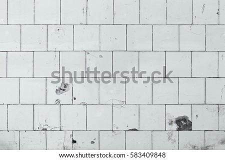 Old ceramic wall tiling wallpaper. White ceramic wall tiling background image. Thin-walled ceramic plates decorative background. Veneered wall home screen. Ceramic wallfacing desktop wallpaper. 