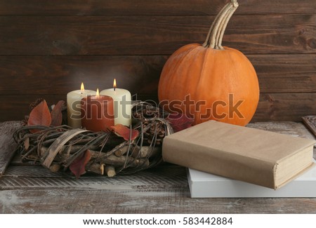 Beautiful autumn composition with pumpkin and books, closeup