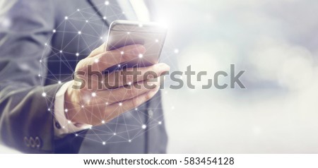 Businessman hand using mobile phone and dots online communication network, copy space