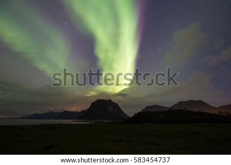 Northern Lights - Aurora borealis. Beautiful picture of massive multicoloured green vibrant Aurora Borealis in the night sky