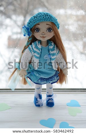 handmade doll in a blue dress