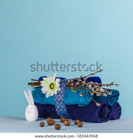 Wellness Easter concept. Set towels in blue colors, rabbit, nuts and branches with kidneys Royalty-Free Stock Photo #583463968