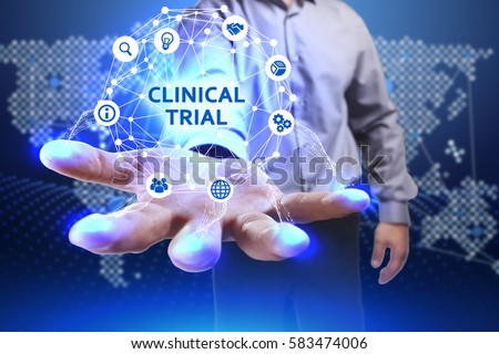 Business, Technology, Internet and network concept. Young businessman shows the word on the virtual display of the future: Clinical trial