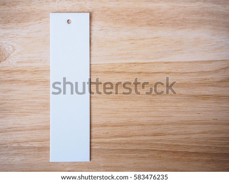 blank white price label on wood background
