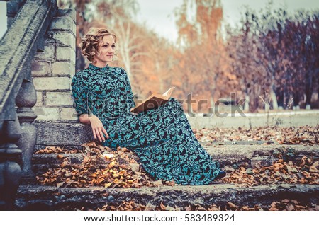 Girl reading on the stairs Royalty-Free Stock Photo #583489324