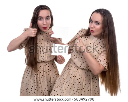 Two cute twins with the blank in hands isolated on white background
