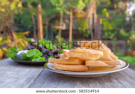 a selective focus picture of a toasted bread plate on wooden table.