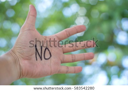 Concept Photo Of A Handwriting Word "NO" On The Left Hand With Blurry Background