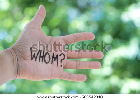 Concept Photo Of A Handwriting Word "WHOM?" On The Left Hand With Blurry Background