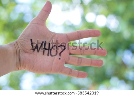 Concept Photo Of A Handwriting Word "WHO?" On The Left Hand With Blurry Background