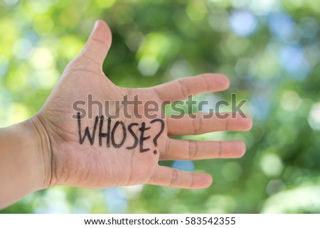 Concept Photo Of A Handwriting Word "WHOSE?" On The Left Hand With Blurry Background