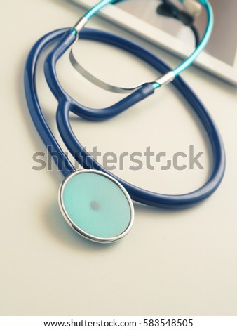 Stesthoscope with a tablet computer on a table, health care concept