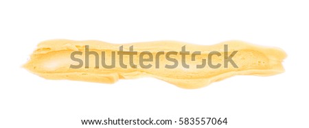 Smeared line of frosting cream isolated over the white background
