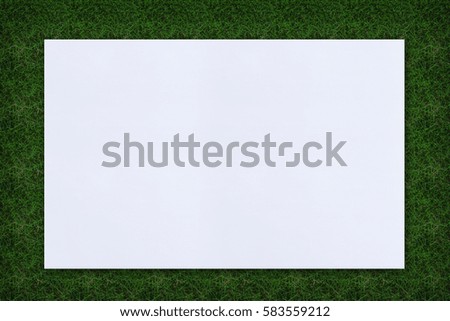 White sheet of paper lying on the grass