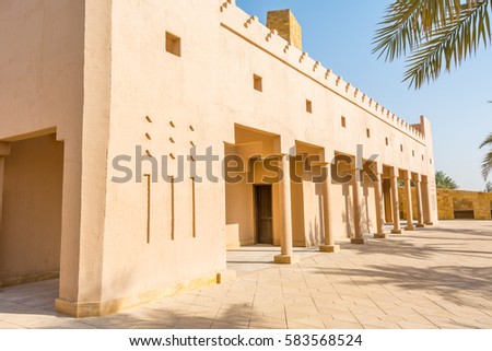 Historic buildings and palm tree in Dariyah clay castle, also as Dereyeh and Dariyya, a town in Riyadh, Saudi Arabia, original home of the Saudi royal family, the capital of the Emirate of Diriyah.