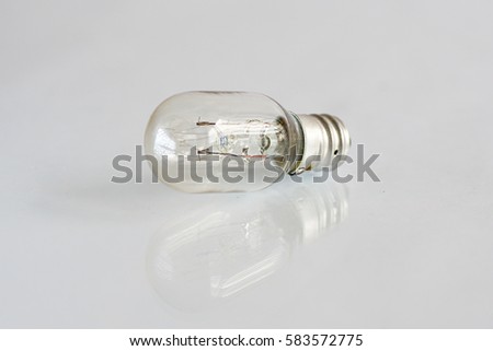 close up lamp bulb on the white isolated background with mirror reflection