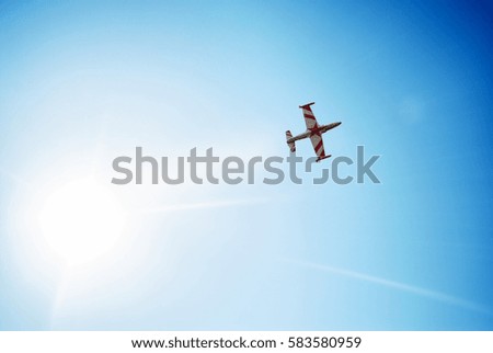 Plane crossing a cloud vignette and sun