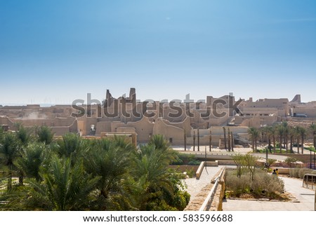 Historic buildings and palm tree in Dariyah clay castle, also as Dereyeh and Dariyya, a town in Riyadh, Saudi Arabia, original home of the Saudi royal family, the capital of the Emirate of Diriyah.