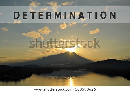 Word DETERMINATION with beautiful backgound of sun coming out from behind the peak of Mount Kinabalu. Concept idea for success, business, motivation, struggle, growth and accomplishment.