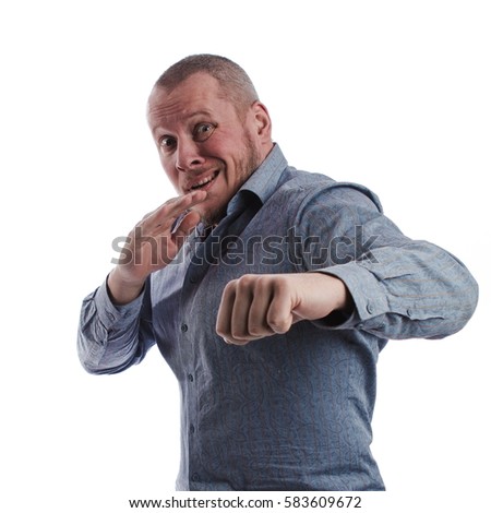 emotional actor man in a gray shirt boxing on a white background in studio