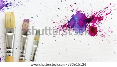 Beautiful and Colorful Flat lay with Brushes and Watercolor splashes on white canvas background. Copy space. Illustration of your art. Free space for your text.