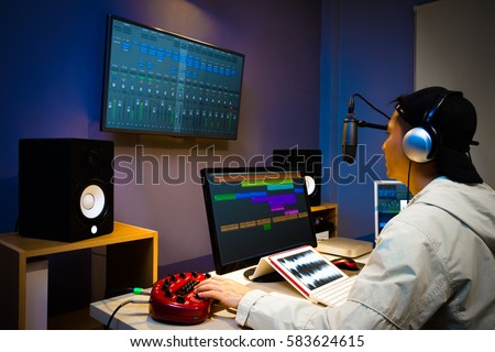 asian male DJ working in digital broadcasting studio, online radio station, podcast, post production technology