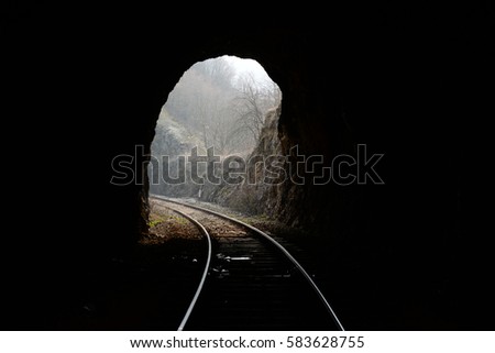 Tunnels and railways. Light on the end of the tunnel Royalty-Free Stock Photo #583628755