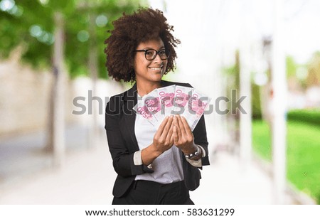 business black woman holding bills