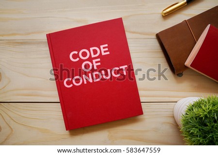 Top view of notebook with word Code of Conduct Royalty-Free Stock Photo #583647559