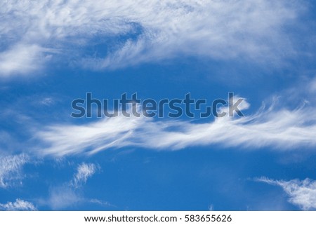 Wisp shape cirrus clouds on blue sky