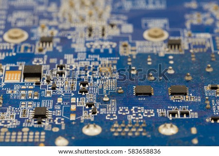 The close up picture of blue computer motherboard. The technology background concept.