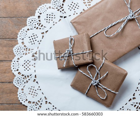 beautiful gifts  on white napkin on the wonderful brown wooden background