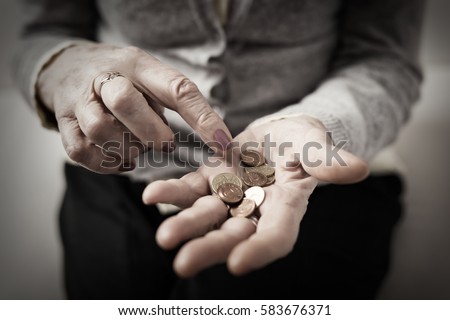 Old woman counting her retirement money 