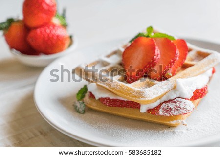 waffle with strawberry on wood table