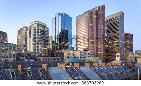 The skyline of Boston in Massachusetts, USA showcasing its mix of contemporary and historic architecture at sunrise.