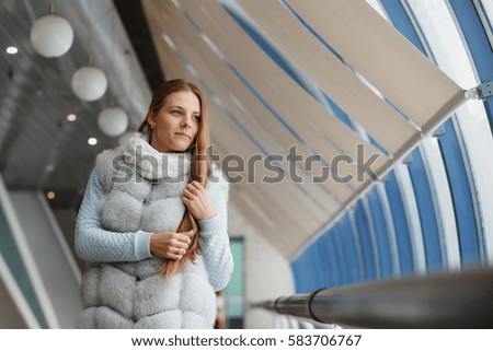 girl in a fur coat walks