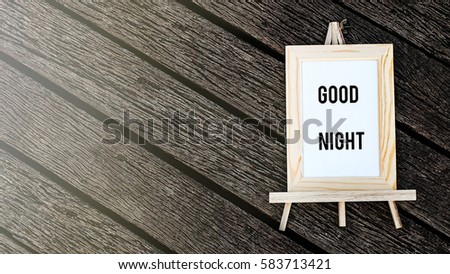 Note good night written on a nice frame over wooden background