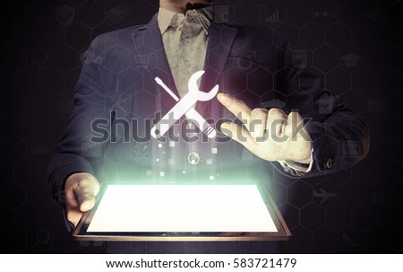 Image of a man with tablet pc in his  hands. He presses technical support button on virtual screen. The concept of customer support, interface customization, etc.