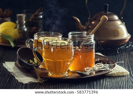 Two Glasses of Steaming Hot Lemon Spiced Tea or Hot Toddies for a Cold Winter's Day Royalty-Free Stock Photo #583771396