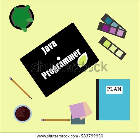 Java Programmer text on laptop computer freelance workspace near plan text notebook and art tools, home office business concept, coffee and plant on table