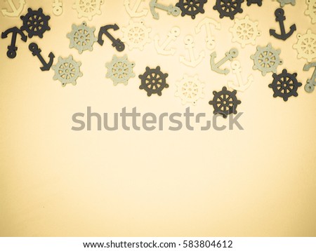 a lot of small anchor and helm on a bright yellow background as the background, substrate, space for text