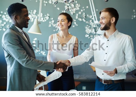 New partners handshaking after negotiation Royalty-Free Stock Photo #583812214