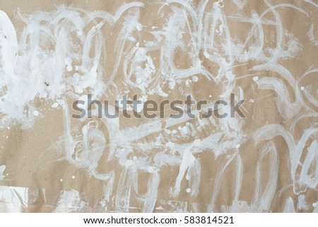 White paint splatters and strokes on recycled craft crumpled paper